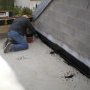 Le couvreur prépare le primaire de la terrasse